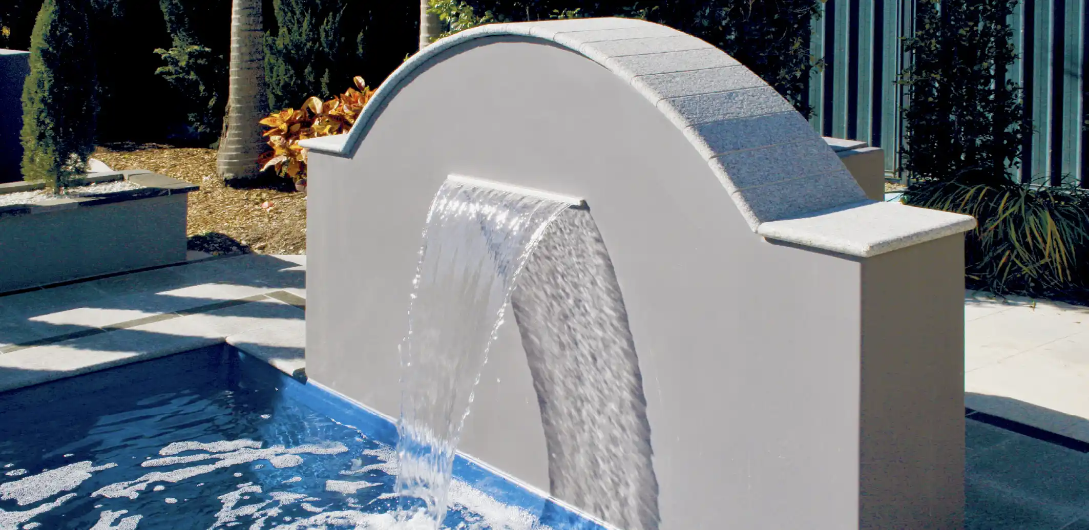 Add a water feature to your backyard pool
